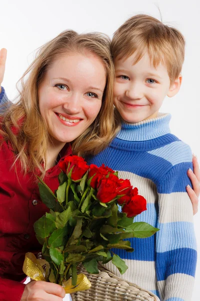 Happy mother and her son with bouquet of flowers — Stock Photo, Image