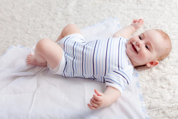 Enfant heureux couché sur le lit — Photo