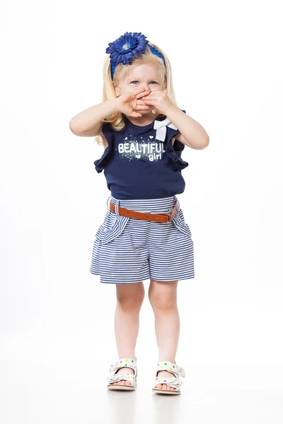 Nice baby girl standing  with her arms closing her face — Stock Photo, Image