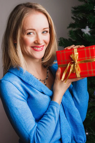 Nice woman with red present — Stock Photo, Image