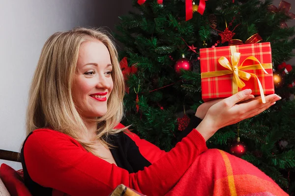 Red gift box in womans hands — Stock Photo, Image