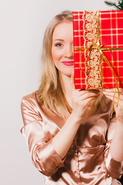 Woman with long blonde hair holding red gift — Stock Photo, Image