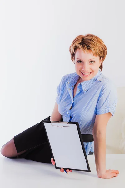 Lovely woman holding empty clipboard — Stock Photo, Image