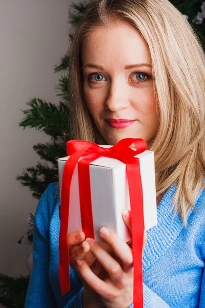 Nice woman keeping present in her hands — Stock Photo, Image