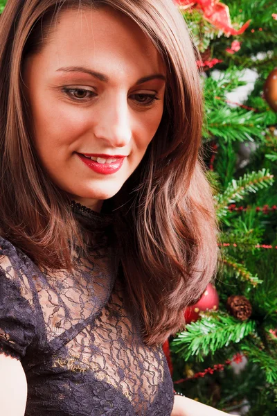 Mooie vrouw met lang haar in de buurt kerstboom — Stockfoto