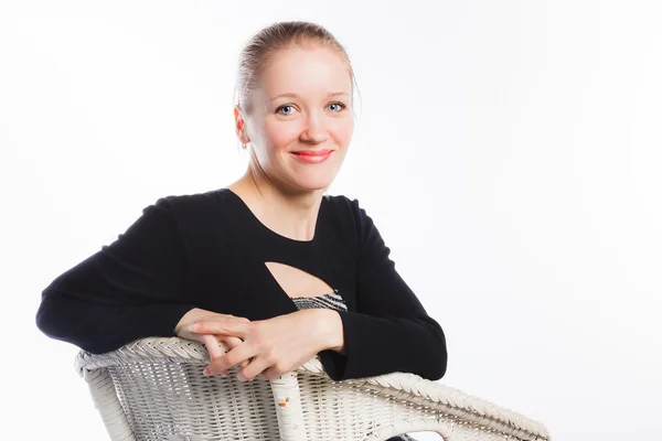 Happy woman resting on arm-chair — Stock Photo, Image