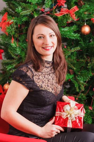 Pretty woman holding red gift — Stock Photo, Image