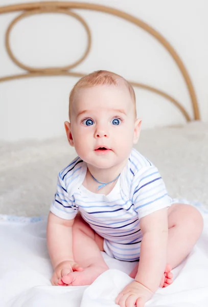 Cute baby boy sitting on bed — Stock Photo, Image