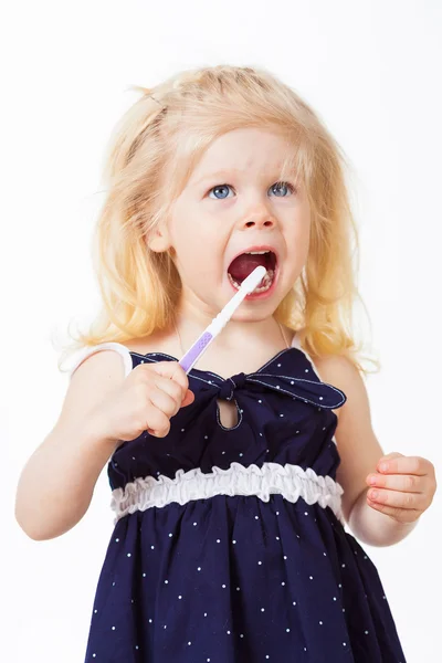 Cute blonde girl cleans her teeth — Stock Photo, Image