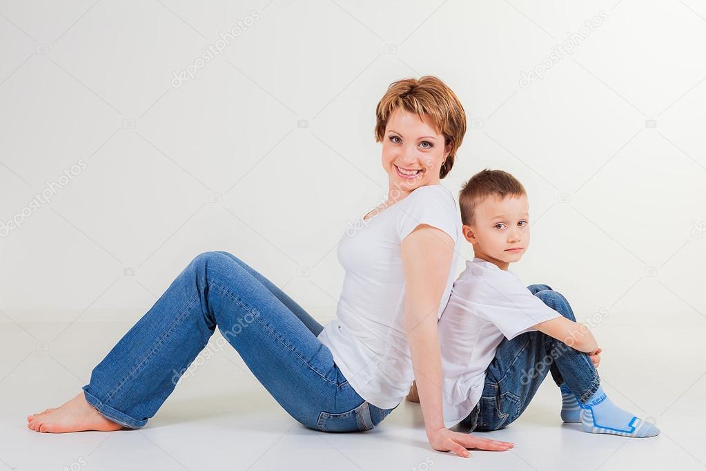 Woman with little boy  sitting back to back
