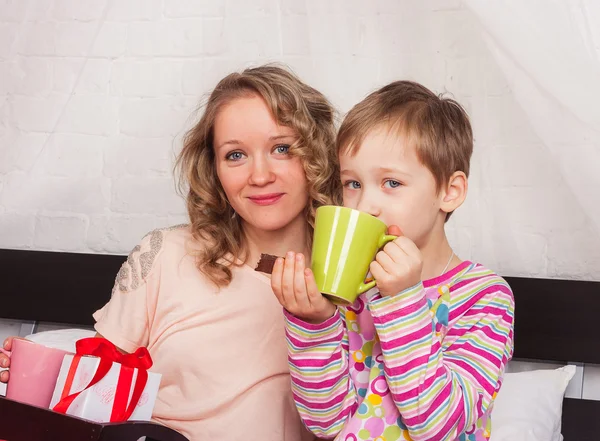 Boy drinking tea with his mom — Stock Photo, Image