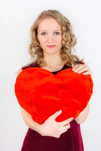 Cute blonde woman standing with red heart — Stock Photo, Image