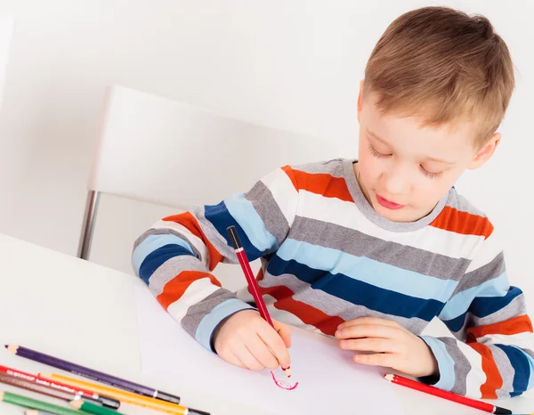 Little boy drawing on whiter paper — Stock Photo, Image