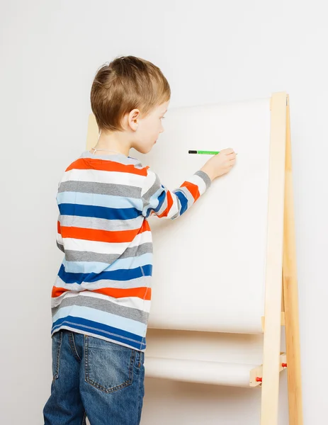 Little boy drawing on easel Royalty Free Stock Photos