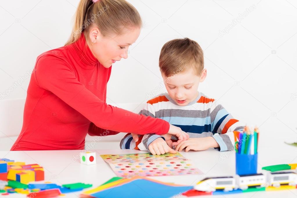 Mother and her son playing  in  board game