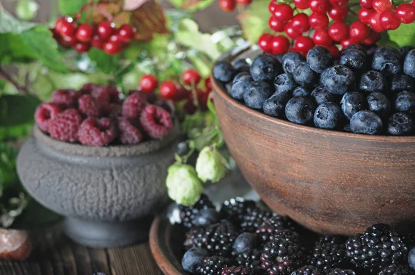 Ripe Blueberries Raspberries Blackberries Viburnum Ceramic Vases Wooden Table — Stock Photo, Image