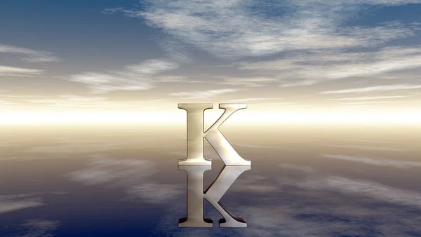 Metal uppercase letter k under cloudy sky - 3d rendering — Stock Photo, Image
