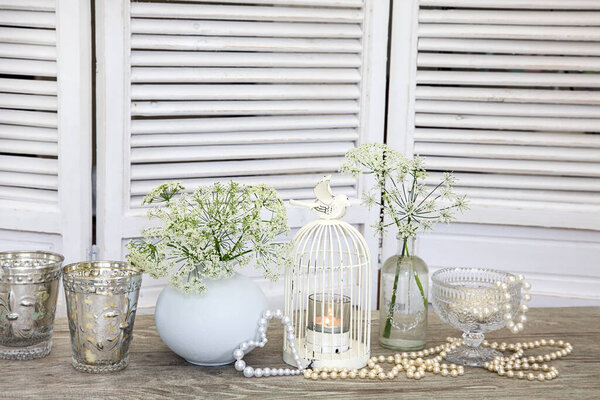 nostalgic still life with white items across white vintage wooden shutters
