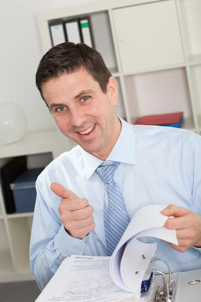 Businessman Flipping Through Book Giving Thumbs Up — Stock Photo, Image