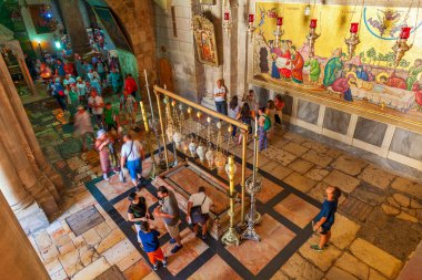 Tourists around Stone of Anointing in the Church of the Resurrec clipart