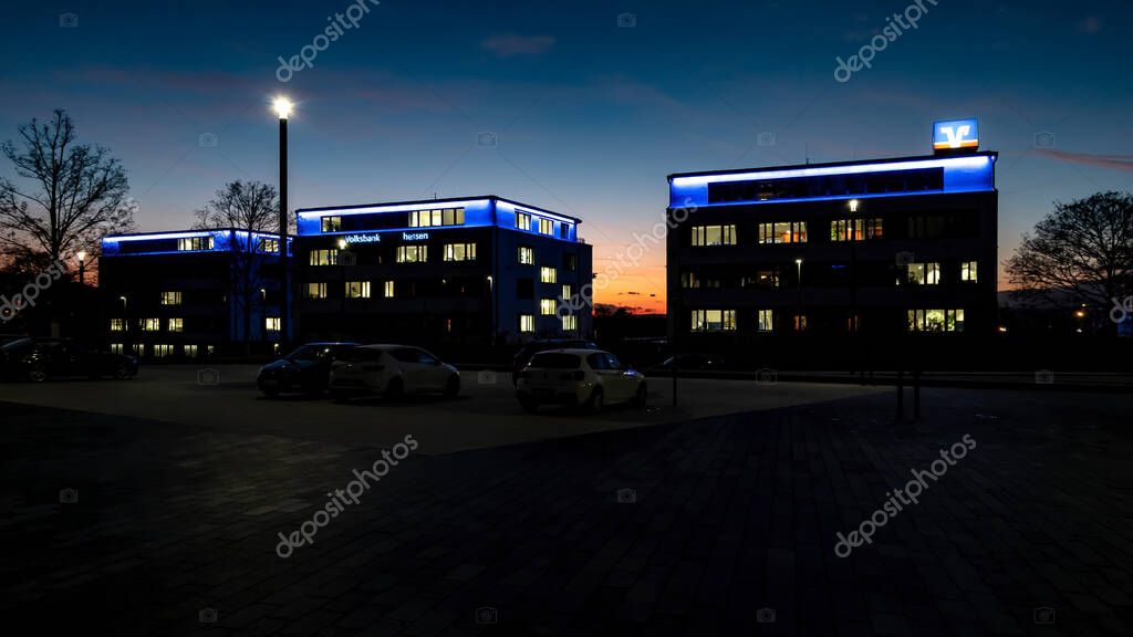 WETZLAR, GERMANY-2020-08-27: Volksbank Mittelhessen eG Buildings at Night. Volksbank Mittelhessen is a cooperative bank. In Germany, cooperative banks are usually banks in the legal form of a registered cooperative.