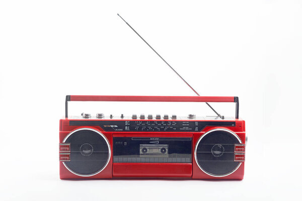 Red vintage Cassette player with open antenna isolated on white background