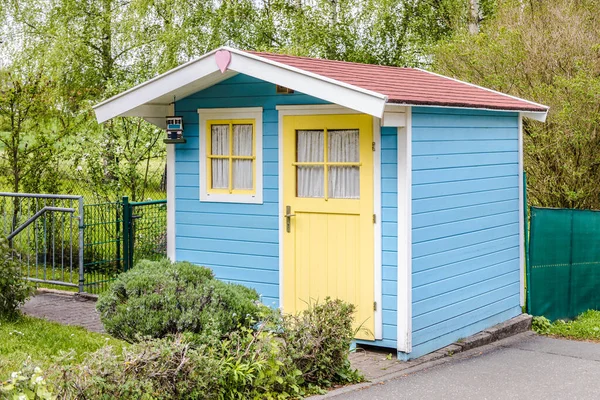 Small Garden Shed or Tool Shed with yellow Door