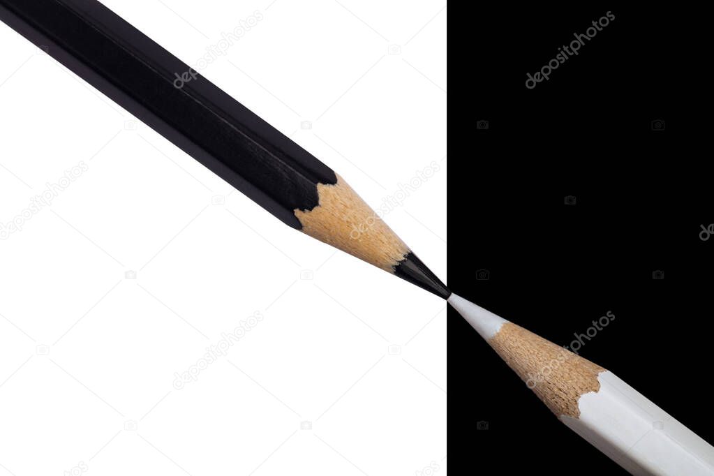 White and black pencils. Conceptual symbol photo shows Opposite Pole