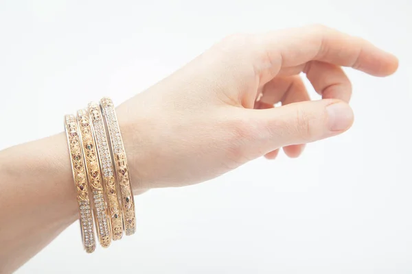 Female Hand Set Golden Bracelets White Background Selective Focus — Stock Photo, Image