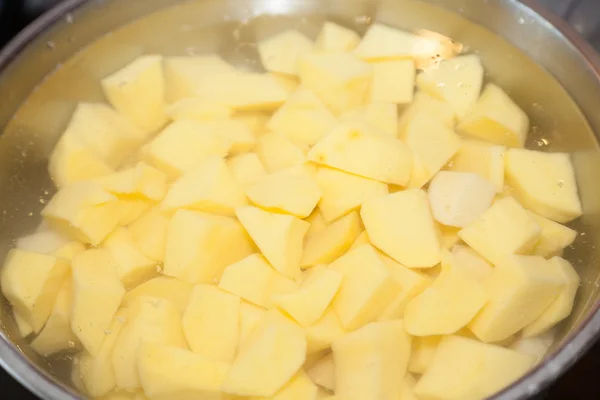 Closeup of potatoes cut in pieces — Stock Photo, Image