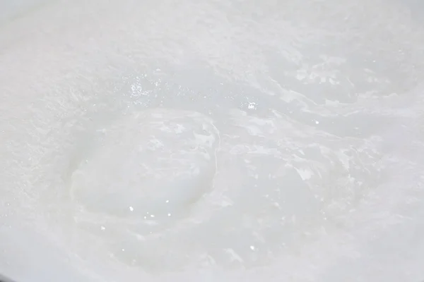 Boiling milk with bubbles — Stock Photo, Image