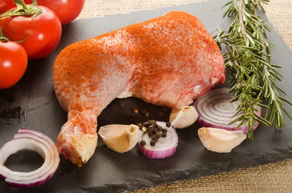 Raw chicken leg with ground paprika — Stock Photo, Image