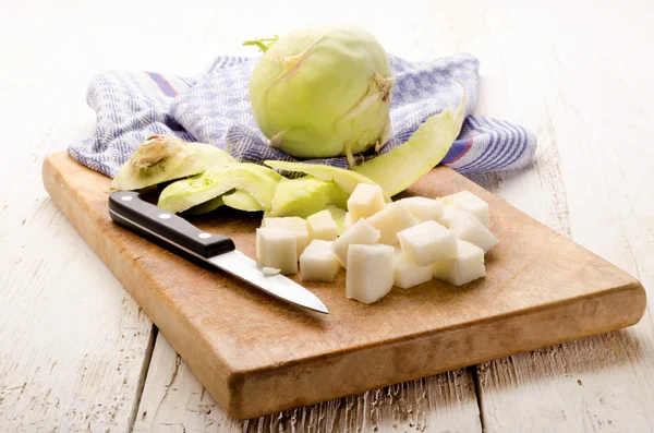 Kohlrabi pelado y cuchillo de cocina en una tabla de madera —  Fotos de Stock