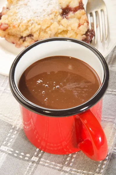 Hot chocolate in a red enamel mug — Stock Photo, Image
