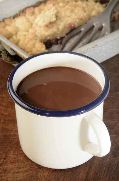Enamel cup with hot chocolate — Stock Photo, Image
