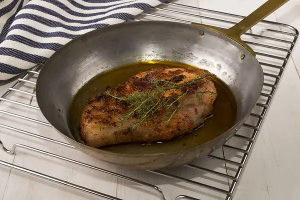 Grilled peppered pork chop in a brass pan with thyme — Stock Photo, Image