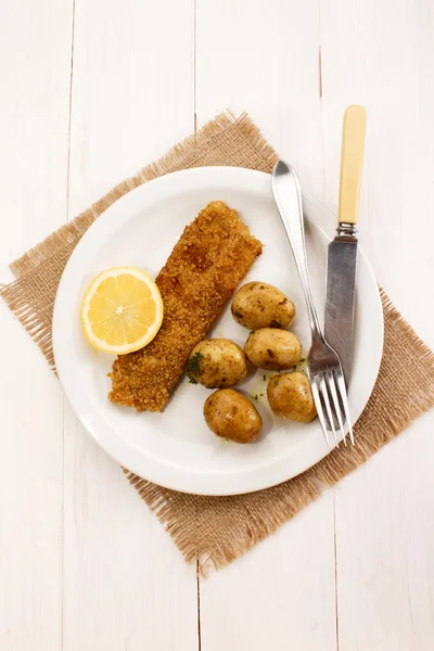 Scottish meal with kipper coated in oat bran and herb potato — Stock Photo, Image