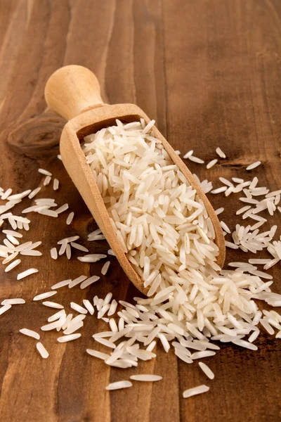 Wooden shovel with basmati rice — Stock Photo, Image