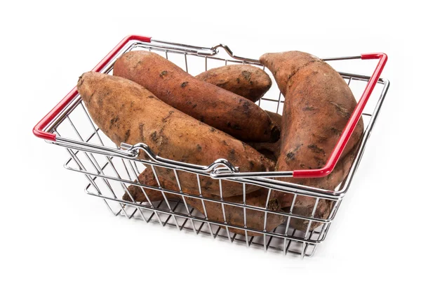 Sweet potatoes in a metal shopping basket isolated on white — Stock Photo, Image