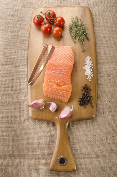 Fresh salmon fillet on wooden board — Stock Photo, Image