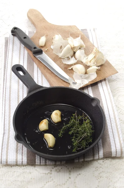 Garlic and thyme in a pan — Stock Photo, Image
