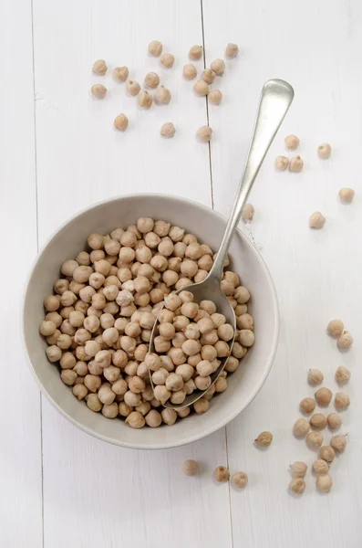 Chickpea in a bowl with spoon — Stock Photo, Image