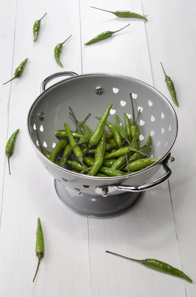 Fresh green chili in a colander — Stock Photo, Image