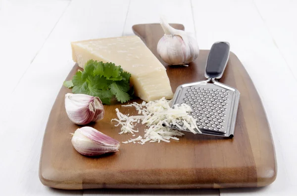 Italian parmesan cheese with garlic, fresh coriander and grater — Stock Photo, Image