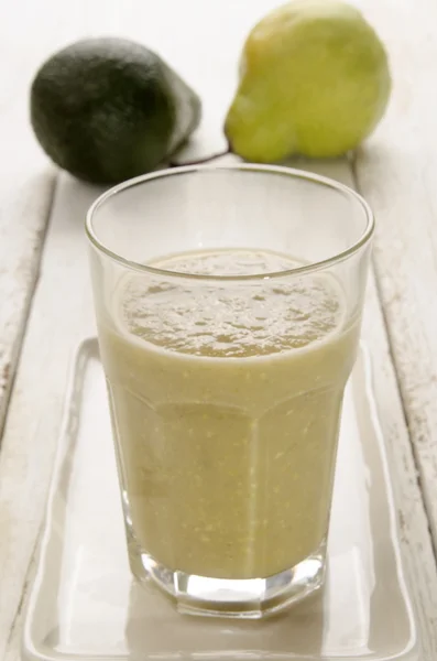 Avocado and pear smoothie in a glass — ストック写真