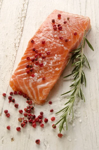 Raw salmon fillet on white rustic wood — Stok fotoğraf