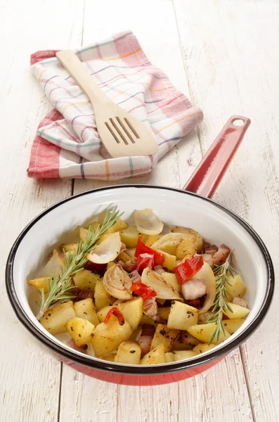 Fried potatoes and bacon in a pan — Stock Photo, Image