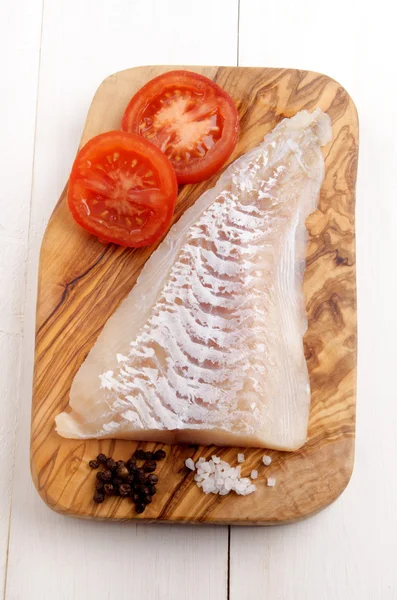 Haddock fillet on a wooden board — Stock Photo, Image