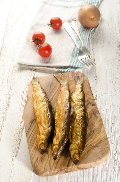 Smoked vendace on wooden board — Stock Photo, Image