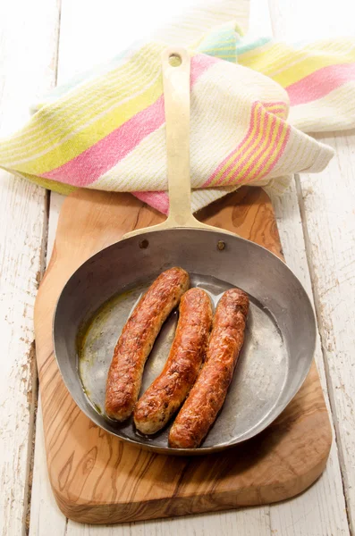 Grilled sausage in a brass pan — Stock Photo, Image